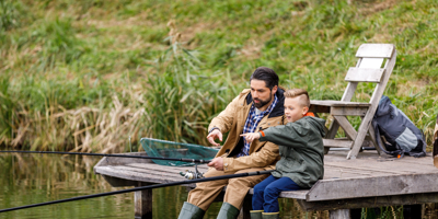Father and son fishing in wooden dock