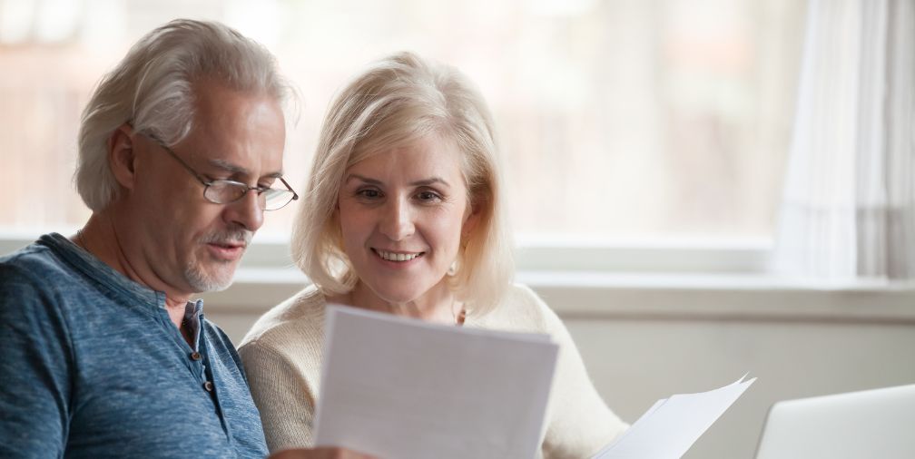 Man and Woman Reading Papers