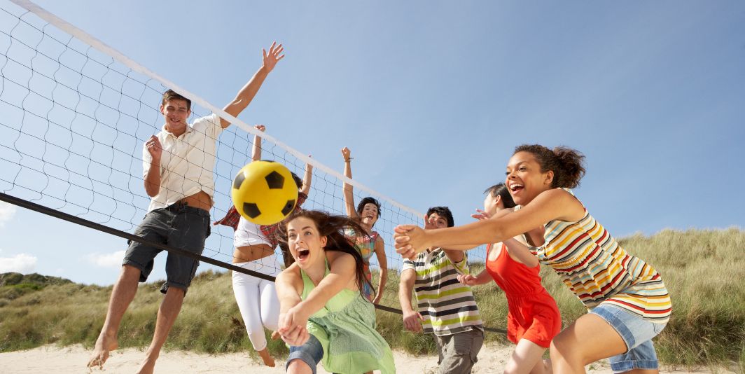 High Schoolers playing beach volleyball