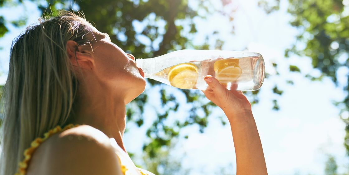 Woman drinking lemon water