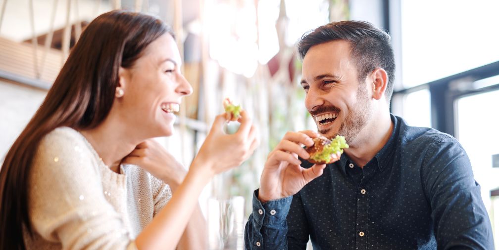 Couple eating dinner and smiling 