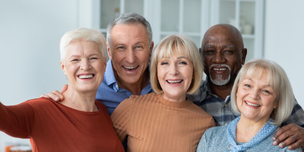 A group of older adults smiling 