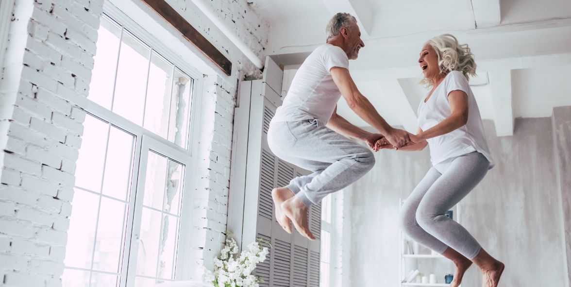 A aged couple jumping