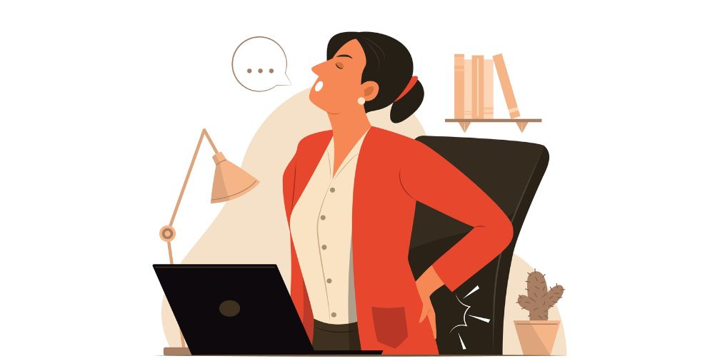 cartoon figure sitting at desk holding her back