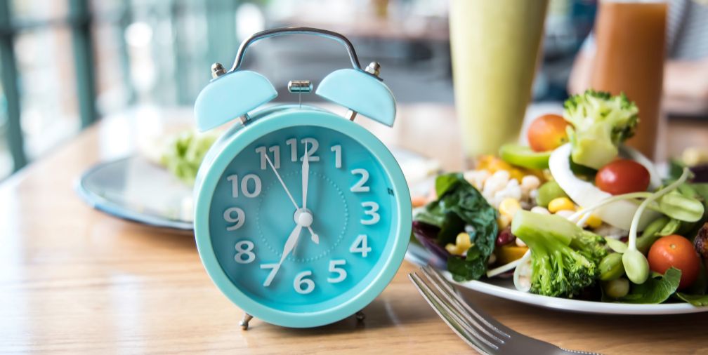 Alarm Clock next to Salad 