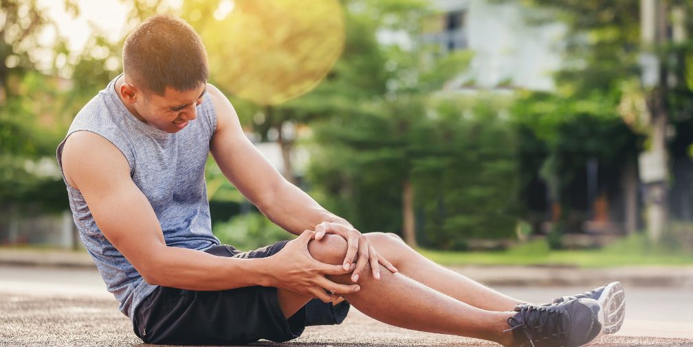 Man holding his knee