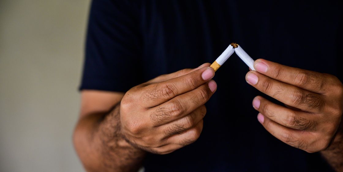 Man breaking a cigarette