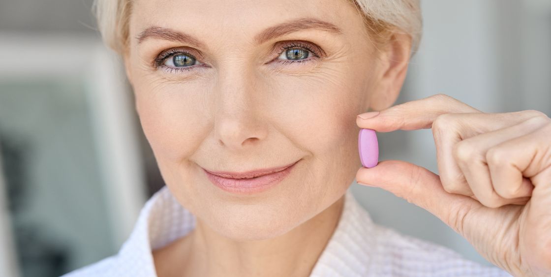 Lady holding a vitamin