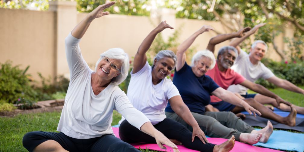 A Group of Older Ladies Doing Yoga 