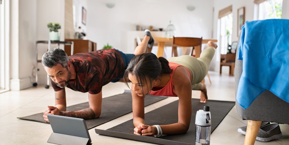Man and Women doing yoga at home
