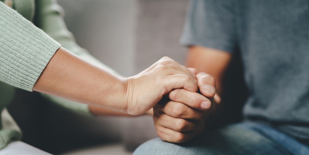 woman holding a man's hand