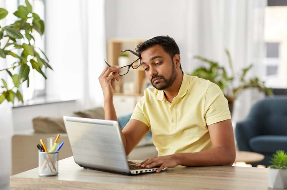 Tired man looking at a computer