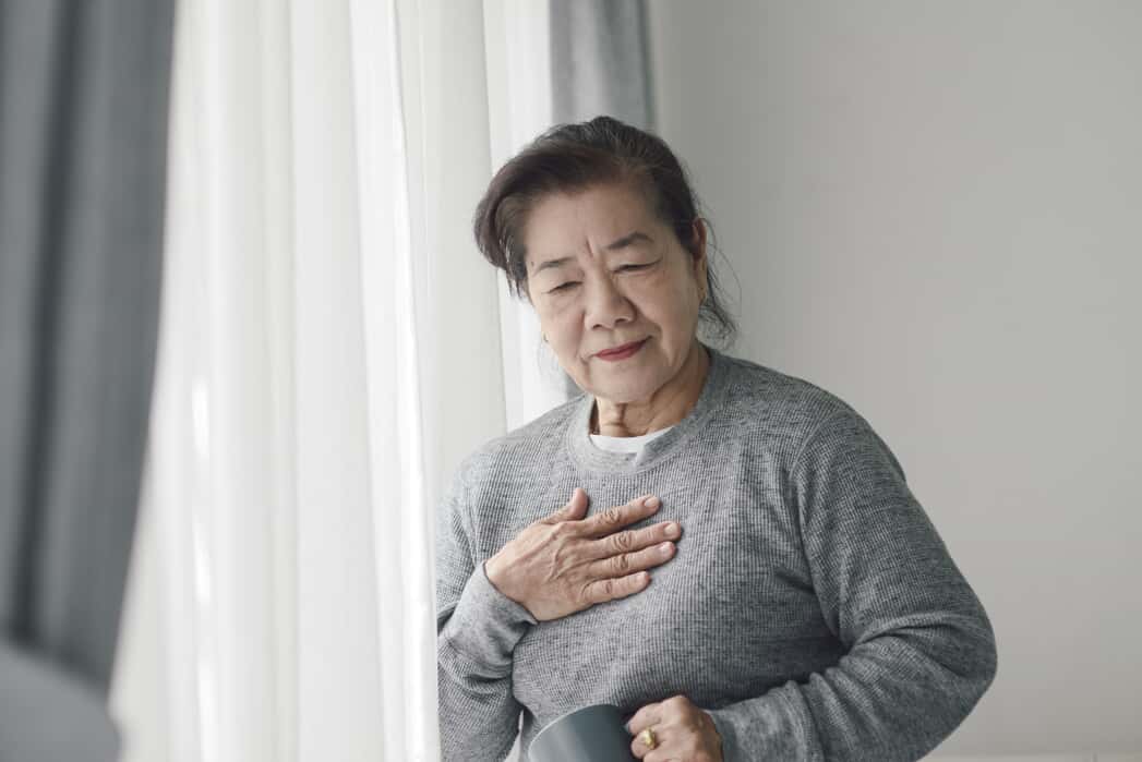 Woman Holding Her Chest