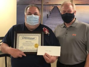 Dave Tracy, EMT (left), is congratulated by Steve Barnett, McKenzie President and CEO, as he celebrates his retirement after 36 years with McKenzie.