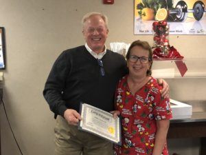 Steve Barnett, President & CEO at McKenzie Health System, presents a longevity award to Debbie Smielewski for 45 years of service.