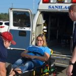 Emily Bell is helped by Sanilac EMS Staff Korey Holland (left) and David Palach.