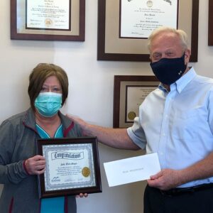 Julie Wolschleger receives congratulations from McKenzie President and CEO Steve Barnett as she retires after 25 years.