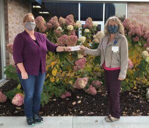 Mary Heiden (left) presenting a check to Nina Barnett, McKenzie Health System Foundation Coordinator.